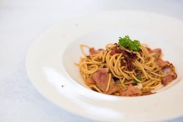 Stir-fried spaghetti spicy bacon, Asian fusion food traditional Thai style.