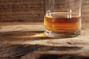 close up scotch whiskey in glass on a wooden table with a blank space for a text, scotch whiskey in rustic bar background
