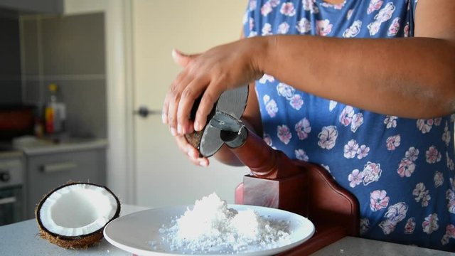 A woman scraping coconut for cooking. This method of scraping is popular in Sri Lanka, India and Malaysia.