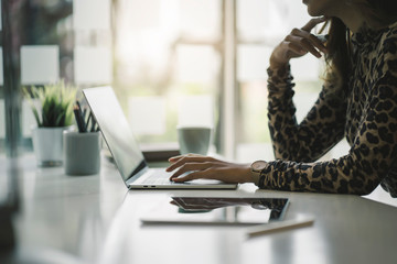 Portrait of beautiful smiling young  entrepreneur businesswoman working in modern work station.