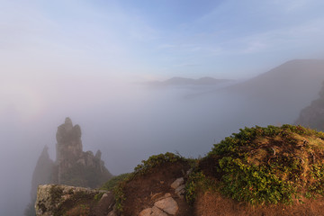 Obraz premium Landscapes of the Ukrainian Carpathian Mountains, with dramatic evening skies and mystical fogs among the rocks.