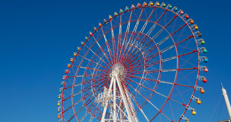 Ferris wheel over blue sky