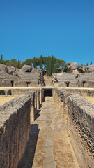 Ruins of the splendid amphitheater, part of archaeological ensemble of Italica, city with a strategic role in the Roman Empire, birthplace of Emperors Trajan and Hadrian, in Santiponce, Seville, Spain