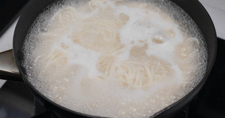 Cooking with somen in skillet in the kitchen