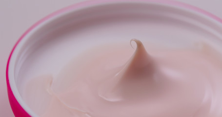 Pink cosmetics cream close up