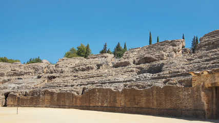 Ruins of the splendid amphitheater, part of archaeological ensemble of Italica, city with a strategic role in the Roman Empire, birthplace of Emperors Trajan and Hadrian, in Santiponce, Seville, Spain