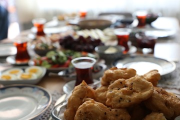 Huge healthy breakfast spread on a table with coffee, orange juice, fruit, muesli, smoked salmon, egg, croissants, meat and cheese.turkey