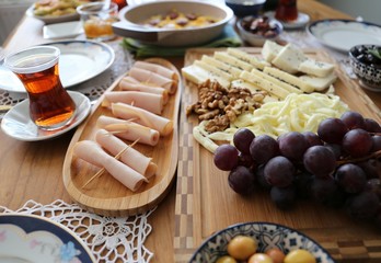 Huge healthy breakfast spread on a table with coffee, orange juice, fruit, muesli, smoked salmon, egg, croissants, meat and cheese.turkey