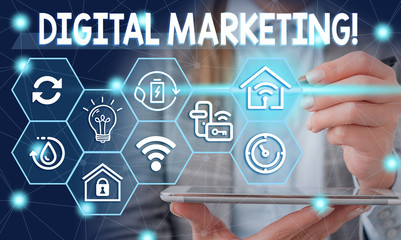 Conceptual hand writing showing Digital Marketing. Concept meaning market products or services using technologies on Internet Female human wear formal work suit presenting smart device