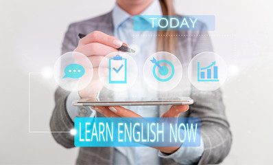 Handwriting text Learn English Now. Conceptual photo gain or acquire knowledge and skill of english language Female human wear formal work suit presenting presentation use smart device
