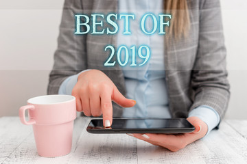 Fototapeta na wymiar Handwriting text writing Best Of 2019. Conceptual photo great and marvelous things and events happened on 2019 Business woman sitting with mobile phone and cup of coffee on the table