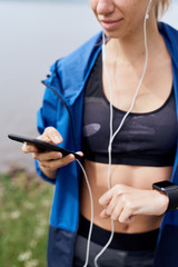 Female sportsman synchronizing gadgets outdoor