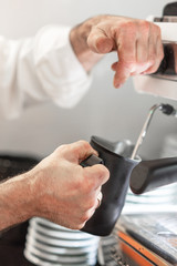 Barista Steaming Milk For Hot Cappuccino .