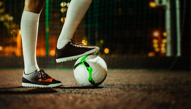 Soccer player in boots and golfs on the training ground. Soccer game concept.