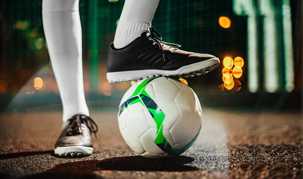 Soccer player in boots and golfs on the training ground. Soccer game concept.