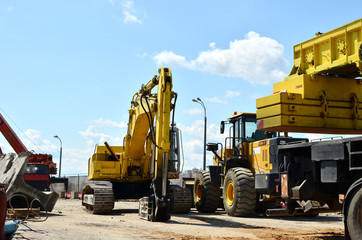 Crawler excavator with hydraulic hammer for the destruction of concrete and hard rock at the construction site.