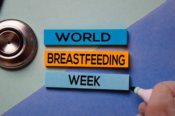 World Breastfeeding Week text on sticky notes isolated on office desk Concept