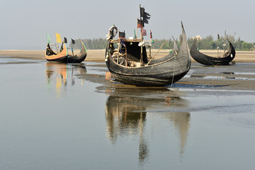 The traditional fishing boat (Sampan Boats) moored on the longest beach, Cox's Bazar in Bangladesh.