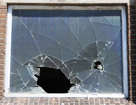 old shattered window made of safety glass