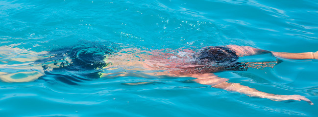 A man swims in the water in the water