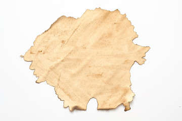 Aged beige paper with burnt edge on white background. Grunge abstract design. Copy space.
