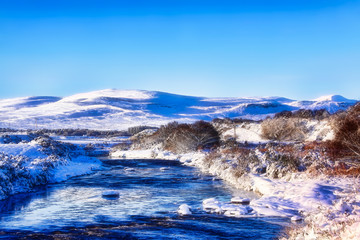 River Brora in winter with Ben Horn covered in snow