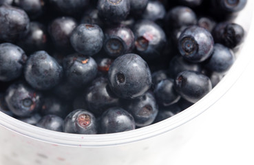 Blueberries in a glass on a white background