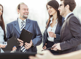 Manager and business team are preparing for the beginning of the working meeting