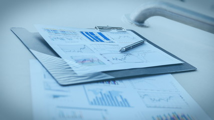 pen and financial documents on the desktop in the office