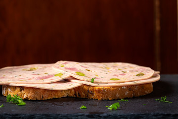 Open sandwich with Salami made from green vegetables like olives and pepper