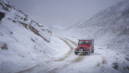 Red car on a snowy mountain