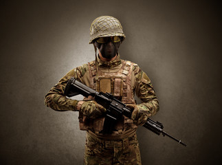 Soldier agent in a dark room with arms on his hand and gas mask
