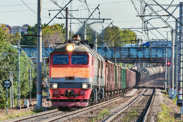 Freight train moves under the bridge.