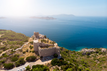 Fototapeta na wymiar Photo of ancient fortress, sea, blue clear sky, mountain fortress.
