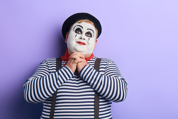 cheerful smiling plump man keeps palms together under chin and looking up. close up portrait, performance. love. copy space