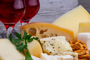 Different types of cheeses with wine glass. Close-up
