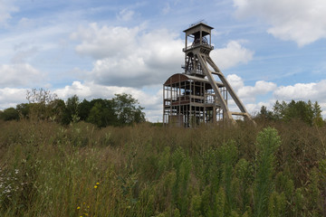 A dramatic sky with former elevator shaft for the coal mines in Maasmechelen, Belgium nowadays converted area and being part of a free public park