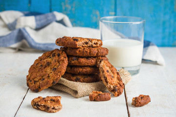 chocolate cookies stack glass of milk on rustic wooden background