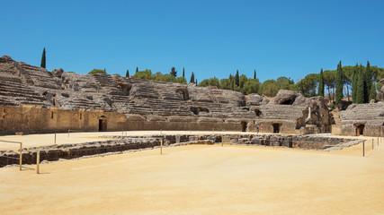 Ruins of the splendid amphitheater, part of archaeological ensemble of Italica, city with a strategic role in the Roman Empire, birthplace of Emperors Trajan and Hadrian, in Santiponce, Seville, Spain