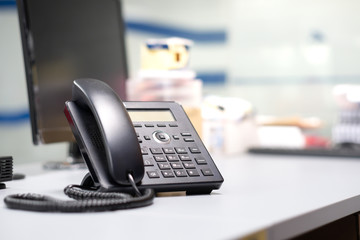 Soft focus Analog telephone black color put on desk office