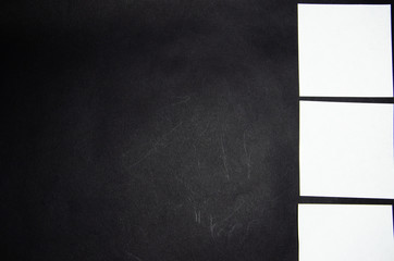 White square stickers of paper of the same size on a black background