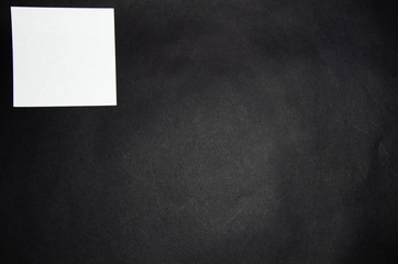 White square stickers of paper of the same size on a black background