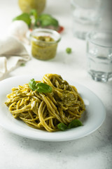 Pasta with pesto sauce and fresh basil leaves