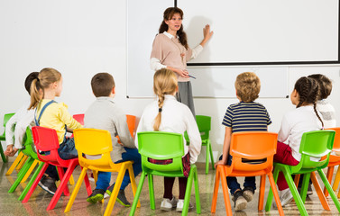 Teacher conducting lesson for school children