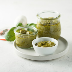 Homemade pesto sauce in jars