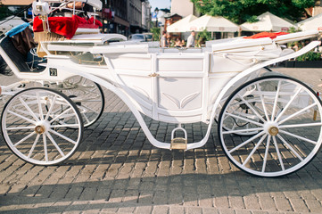Fototapeta na wymiar Closeup white carriage in Krakow (Cracow ) on the street