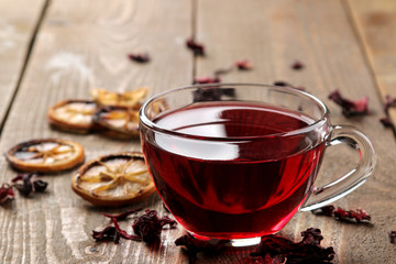 Hibiscus red tea in glass cups on a brown wooden table. a warming drink. autumn or winter drink