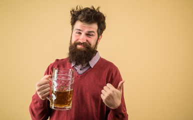 Oktoberfest. Bearded man holds glass with delicious ale. Man tasting draft beer. Bearded hipster drinking beer. Drunk man with glass of craft beer. Alcohol. Man drinking draught beer at bar or pub.