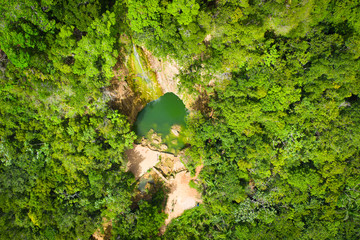 Scenic aerial view of El Limon waterfall in jungles of Samana peninsula in Dominican Republic. Amazing summer look of cascade in tropical forest from above. - obrazy, fototapety, plakaty