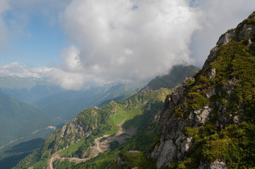 August summer day in the forest of the Caucasus mountains in a park of waterfalls on a mountain river.